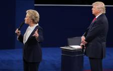 US Democratic presidential candidate Hillary Clinton and US Republican presidential candidate Donald Trump debate during the second presidential debate at Washington University in St. Louis, Missouri, on 9 October, 2016. Picture: AFP.