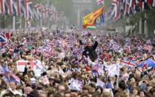 Royal supporters wave British Union Jack flags during the royal wedding in central London on April 29, 2011. Picture: AFP
