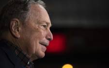 Democratic presidential candidate Mike Bloomberg has an aide take his daily briefings binder before speaking to supporters at the Viva Villa restaurant in San Antonio, Texas on 11 January 2020. Picture: AFP