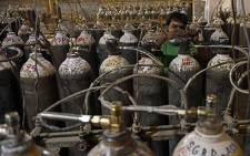 Workers are seen sorting oxygen cylinders that are being used for Covid-19 coronavirus patients before dispatching them to hospitals at a facility on the outskirts of Amritsar on April 28, 2021. Picture: Narinder Nanu / AFP.