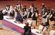 FILE: Members of the Taliban delegation leave their seats at the end of the session during the peace talks between the Afghan government and the Taliban in the Qatari capital Doha on 12 September 2020. Picture: AFP