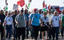 (L-R) Cuba's Prime Minister Manuel Marrero, Cuba's President Miguel Diaz-Canel, and his wife Lis Cuesta take part in a march in support of the Palestinian people in Havana, on 23 November 2023. Picture: AFP