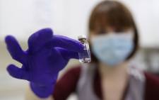 An NHS pharmacy technician holds a vial as she simulates the preparation of the Pfizer-BioNTech coronavirus vaccine during a staff training session ahead of the vaccine's rollout on 8 December 2020. Picture: AFP.