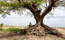 FILE: A UN soldier keeps watch by Lake Albert as his platoon sets up camp for the night in the abandoned village of Kafe, on 27 March 2018. Picture: AFP.