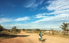A man cycles in Vuwani as the town is shut down during protest action. Picture: Thomas Holder/EWN