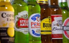 Bottles of beer and cider produced by Belgian-Brazilian group Anheuser-Busch InBev, (Budweiser, Corona, Stella and Beck’s) and British brewer SABMiller (Peroni and Bulmers). Picture: AFP.