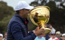 USA team member and captain Tiger Woods holds the Presidents Cup after their win over the International team following the golf tournament in Melbourne on 15 December 2019. Picture: AFP