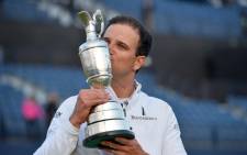 US golfer Zach Johnson kisses the Claret Jug, the trophy for the Champion golfer of the year as he poses for a photograph after winning the three-way playoff on day five of the 2015 British Open Golf Championship on The Old Course at St Andrews in Scotland, on 20 July, 2015. Picture: AFP.