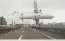A TransAsia Airways passenger plane hit a bridge in Taipei City, in Taiwan before plunging into the river. Picture: AFP
