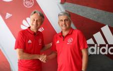 New Ajax Cape Town head coach Muhsin Ertugral (left) shakes hands with club CEO Ari Efstathiou (right). Picture: Twitter/@ajaxcapetown