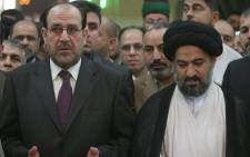 Iraq's Prime Minister Nuri al-Maliki (L) prays with Sayyed Ahmed al-Safee (R), the representative of Shiite Muslim Grand Ayatollah Ali al-Sistani, at the Imam Abbas shrine in the southern city of Karbala some 120 kilometers south of Baghdad late on 12 September, 2008. Picture: AFP