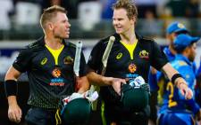 FILE: Australia's David Warner (L) speaks with Steve Smith after victory during the Twenty20 match between Australia and Sri Lanka at the Gabba in Brisbane on 30 October 2019. Picture: AFP