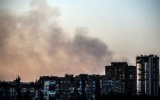 Smoke rises over Donetsk city on 27 July 2014. Picture: AFP.