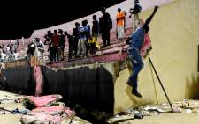 People look at the scene after a wall collapsed at Demba Diop stadium 15 July 2017 in Dakar after a football game between local teams Ouakam and Stade de Mbour. Picture: AFP
