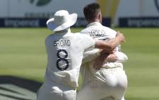 England's Stuart Broad (L) celebrates with teammate England's Mark Wood (R) after the dismissal of South Africa's Rassie van der Dussen during the fourth day of the fourth Test cricket match between South Africa and England at the Wanderers Stadium in Johannesburg on 27 January 2020. Picture: AFP