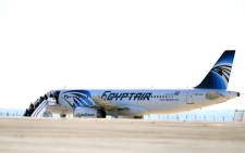 Passengers leave an EgyptAir Airbus A-320 sitting on the tarmac of Larnaca airport after it was hijacked and diverted to Cyprus on March 29, 2016. Picture: AFP