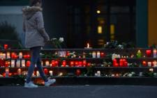 A girl lays flowers at a memorial in front of the Joseph-Koenig-Gymnasium secondary school in Haltern am See, western Germany on March 24, 2015, from where some of the Germanwings plane crash victims came. Picture: AFP.