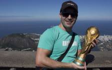 EWN Sport's Marc Lewis poses with the World Cup trophy replica in Rio de Janeiro on 6 July 2014. Picture: Christa Eybers/EWN.