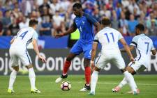 France midfielder Paul Pogba (C) controls the ball under pressure from England midfielders Aaron Cresswell (L), Alex Oxlade-Chamberlain (2R) and Raheem Sterling (R) during their international friendly match. Picture: AFP