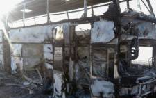 A handout picture provided by the Kazakh emergency situations ministry on 18 January, 2018 shows a charred bus on a road in the region around the city of Aktobe. Picture: AFP