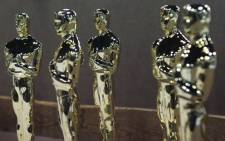 Oscar statuettes sit on a work bench prior to being assembled at R.S. Owens & Company during a media demonstration 9 February 2012 in Chicago, Illinois. Picture: AFP.