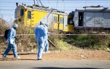 The pathology team arrive at the scene where two trains collided near the Elandsfontein station in Johannesburg on Thursday morning leaving one person dead and over 100 injured. Picture: Reinart Toerien/EWN.