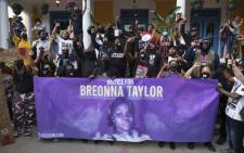 FILE: Demonstrators pose for a photo in front of a local restaurant in the NULU neighborhood on a third day of protest over the lack of criminal charges in the police killing of Breonna Taylor and the result of a grand jury inquiry, in Louisville, Kentucky, on 25 September 2020. Picture: AFP