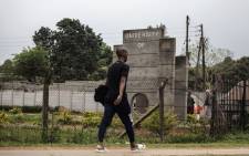 A Swazi man walks past the main entrance of the formerly known University of Swaziland, that will be renamed University of eSwatini. Picture: AFP