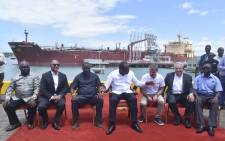 President Uhuru Kenyatta (centre) poses in a group photo with other officials in front of an oil tanker carrying 200,000 barrels of crude oil during the inaugural shipment of crude oil at Kipevu Oil Terminal at Kenya's port city of Mombasa on 26 August 2019. Picture: AFP