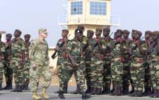 Senegals Army General Amadou Kane (C) and US Army General Donald Bolduc (L) review the troops during the inauguration of a military base in Thies, 70 km from Dakar, on 8 February 8 2016 on the second day of a three-week joint military exercise between African, US and European troops, known as Flintlock. Picture: Seyllou/AFP.