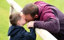 Wayne Rooney kisses his son before practice during the 2014 Fifa World Cup. Picture: AFP. 