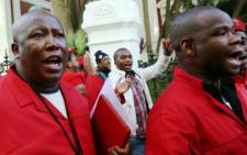 Economic Freedom Fighters leader Julius Malema is seen leaving Parliament in Cape Town on Thursday, 21 August 2014 with EFF MPs. Picture: Sapa.