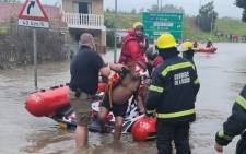 The George fire and rescue service evacuates a man following heavy rain and flooding in the area on 22 November 2021. Picture: George Municipality/Facebook