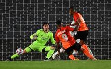 Real Madrid's Belgian goalkeeper Thibaut Courtois (back) blocks a shot on goal during the UEFA Champions League group B football match between Real Madrid and Shakhtar Donetsk at the Alfredo di Stefano stadium in Valdebebas on the outskirts of Madrid on 21 October 2020. Picture: AFP.
