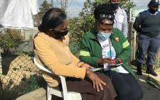 Western Cape Health MEC Nomafrench Mbombo (right) helps Paarl resident Spasie Daniels (84) register for the COVID-19 vaccine on 13 May 2021. Picture: Kevin Brandt/Eyewitness News