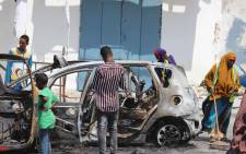 FILE: People start cleaning debris at the site where a car bomb exploded near the Somali parliament in Mogadishu, Somalia, on 8 January 2020.  Picture: AFP