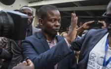 Malawian preacher Shepherd Bushiri waves at supporters as he leaves the Lilongwe Magistrates Court on 19 November 2020, after skipping bail in South Africa and being arrested in Malawi. Picture: AFP