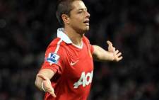 Manchester United's Mexican forward Javier Hernández celebrates after scoring the third goal during the Carling cup on October 26, 2010. Picture: AFP.