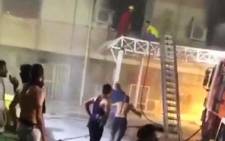 A grab taken from a UGC video obtained from Basim Almohand / ESN, shows Iraqi firefighters battling flames after a fire erupted at the Ibn al-Khatib hospital reserved for the most severe COVID-19 cases, in the capital Baghdad, on April 25, 2021. Picture: Basim Almohand / AFP. 
