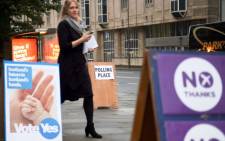 A woman leaves a polling station after casting her vote in Edinburgh, Scotland, on 18 September 2014, during a referendum on Scotland's independence.Picture: AFP.