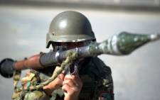 FILE: An Afghan soldier carries a rocket-propelled grenade and launcher. Picture: AFP.