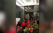 A video screengrab shows EFF MP Marshall Dlamini assault an unknown man after the 2019 State of the Nation Address. Picture: EWN.