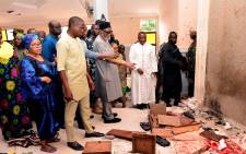 Ondo State governor Rotimi Akeredolu (3rd L) points to blood the stained floor after an attack by gunmen at St. Francis Catholic Church in Owo town, southwest Nigeria on June 5, 2022. Picture: AFP