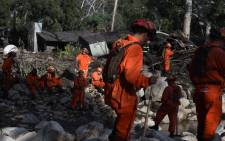 A Cal Fire inmate crew rests while looking for survivors of a massive mudflow in Montecito, California, on 10 January 2018. Picture: AFP