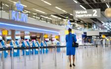 A KLM flight attendant walks in the Schiphol Airport, on January 21, 2021. Picture: Evert Elzinga/AFP.