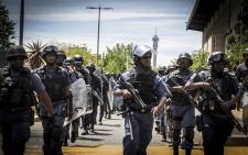 Members of the Saps patrol around Wits University's main campus on 11 October 2016 during protests over tertiary education fees. Picture: Reinart Toerien/EWN.