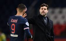 Paris Saint-Germain's Argentinian forward Mauro Icardi (L) and Paris Saint-Germain's Argentine head coach Mauricio Pochettino celebrate after winning the French L1 football match between Paris Saint-Germain and Nimes Olympique at the Parc des Princes stadium in Paris o3 n February 2021. Picture: FRANCK FIFE/AFP