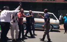 A screengrab of Revelation Church of God church members assaulting a JMPD officer in Johannesburg.