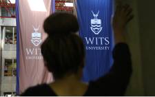 FILE: A Wits University student stands inside a packed hall as student representatives speak during the varsity's third day of protests over proposed tuition fee increases. Picture: Reinart Toerien/EWN.