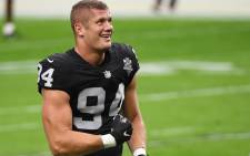 In this file photo Carl Nassib #94 of the Las Vegas Raiders flexes while smiling during warmups before a game against the Denver Broncos at Allegiant Stadium on 15 November 2020 in Las Vegas, Nevada. Picture: ETHAN MILLER/AFP